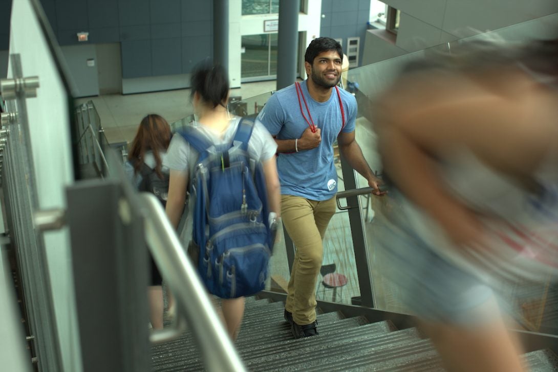 UIC graduate student ascending a staircase