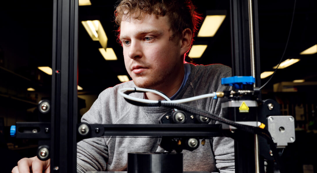 University of Illinois Chicago College of Engineering BME undergraduate Kyle Kinnerk monitors a corrosion cell being made on an FDM 3D printer in the lab.