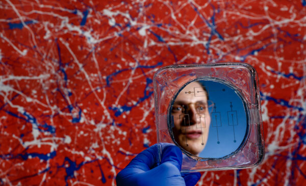 University of Illinois Chicago College of Engineering PhD student Michael Rogy reflected in a Microfluidic mold. Rogy won an NSF graduate fellowship.
