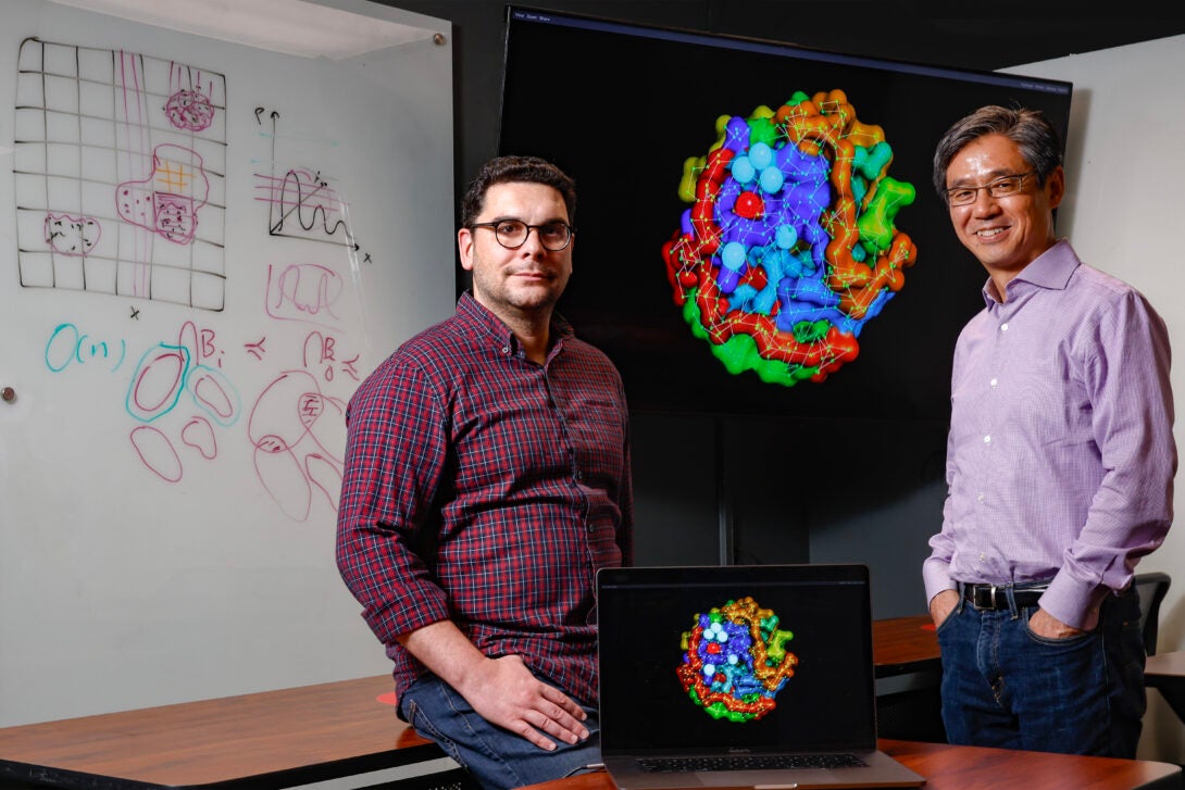 Assistant Professor Kostas Chronis (L) of the Department of Biochemistry and Molecular Genetics and Richard and Loan Hill Professor Jie Liang of the Department of Biomedical Engineering show off research from their DOE INCITE grant.