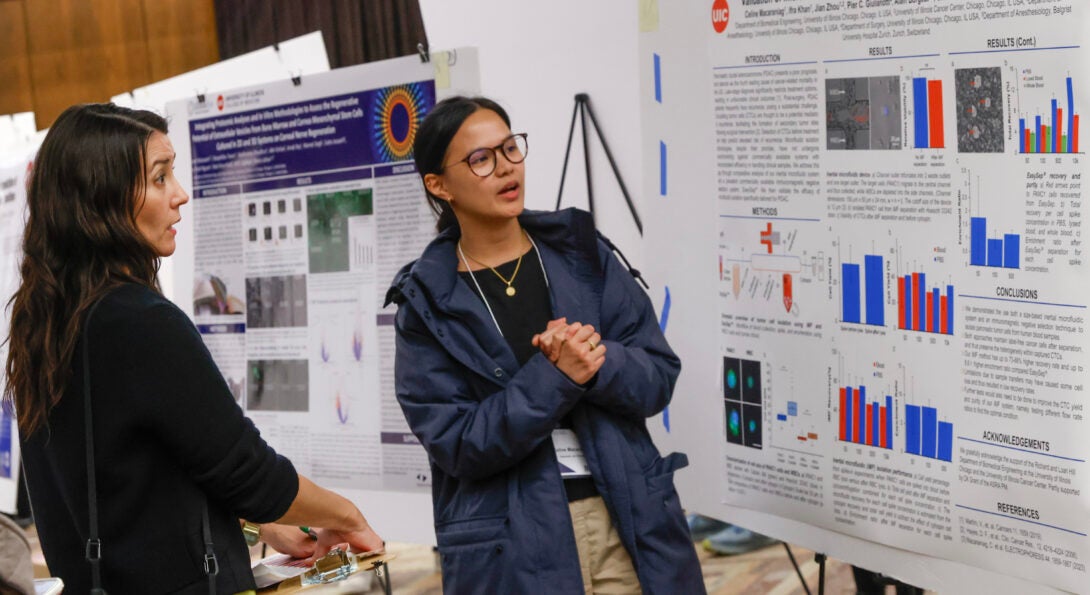 PhD student Celine Macaraniag (right) presents her poster to Richard and Loan Hill Clinical Professor Miiri Kotche at the BMES 6th Annual Research Symposium.