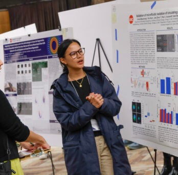 PhD student Celine Macaraniag (right) presents her poster to Richard and Loan Hill Clinical Professor Miiri Kotche at the BMES 6th Annual Research Symposium.
                  