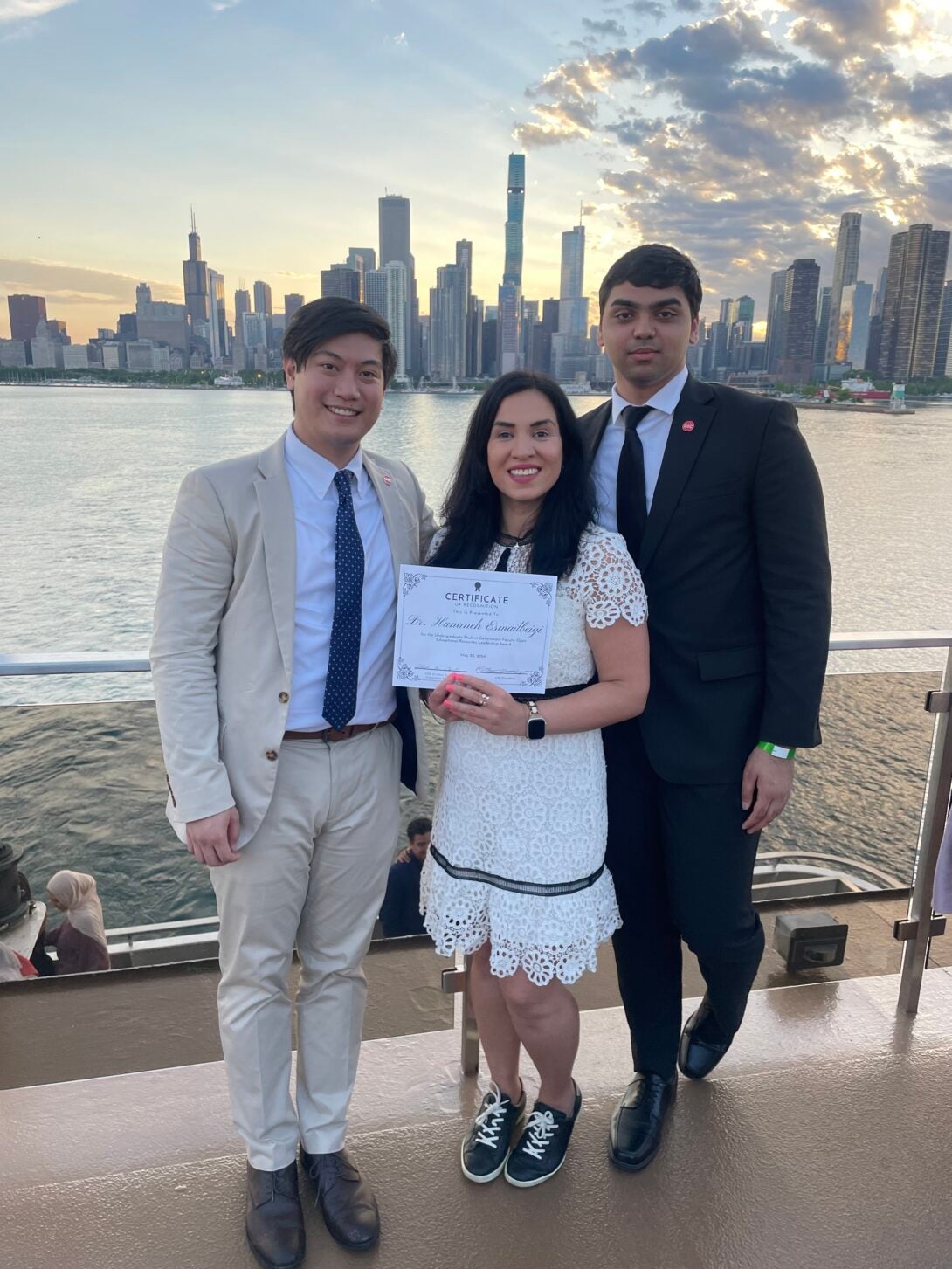 Matthew Almendras, Esmailbeigi, and Asa Asad stand together during the end of the year UIC Student Government cruise.