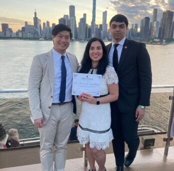 Matthew Almendras, Esmailbeigi, and Asa Asad stand together during the end of the year UIC Student Government cruise. 