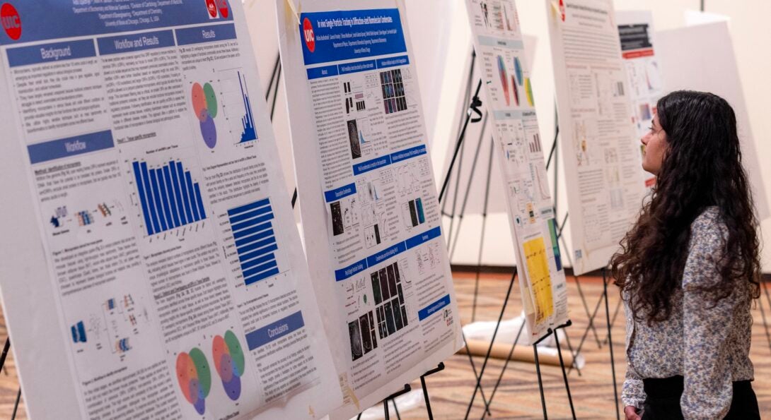 A student learns about the research presented during the poster session at the fourth annual CBQB Research Day.