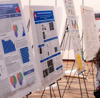 A student learns about the research presented during the poster session at the fourth annual CBQB Research Day.
                  